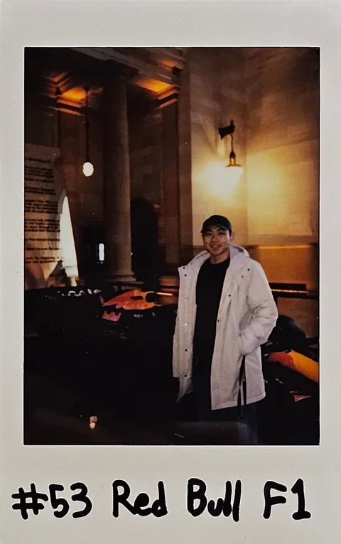 A Polaroid beside a Red Bull Formula 1 display